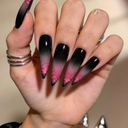 Black And Pink Nails That Look Instantly Chic Long stiletto nails with a glossy black base fade into vibrant pink glitter tips, creating a dramatic ombré effect perfect for a bold black and pink nails look.