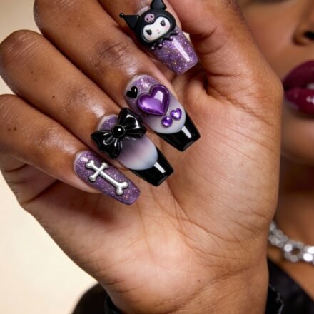 Gothic Valentines Nails That Feel Dark and Romantic Close-up of a hand with gothic valentines nails featuring purple glitter polish, 3D embellishments including a cartoon character, hearts, a bow, a crossbone, and a spike barbell accent.
