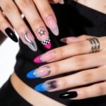 Swaggy Nails That Look Cool and Expensive Close-up of hands showcasing a vibrant mix of edgy Nail Art Ideas, featuring checkerboard patterns, 3D embellishments, ombré blues and pinks, metallic accents, and glossy black polish.