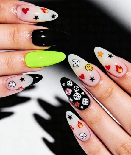 Long almond-shaped nails with a playful mix of translucent and solid colors, decorated with fun symbols like dice, hearts, flames, stars, and a smiley face—perfect swaggy nails for bold Nail Art Ideas.