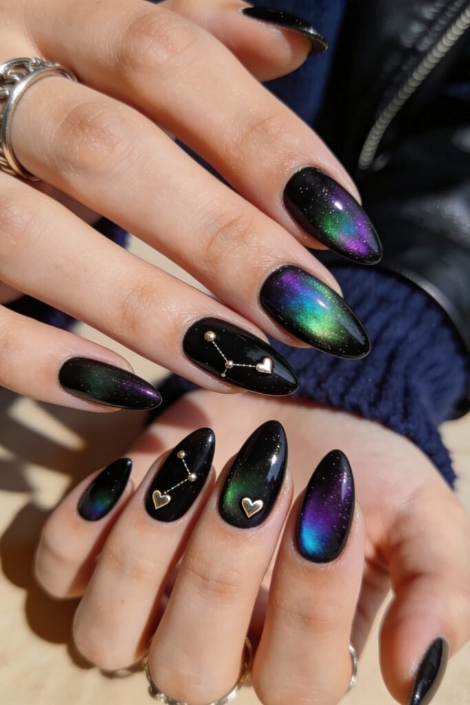 Black Valentines Day Nails That Feel Chic And Romantic 19 Black valentines day nails with an aurora-like shimmer in green, blue, and purple hues, decorated with tiny gold heart and star constellation embellishments for a cosmic romantic vibe.