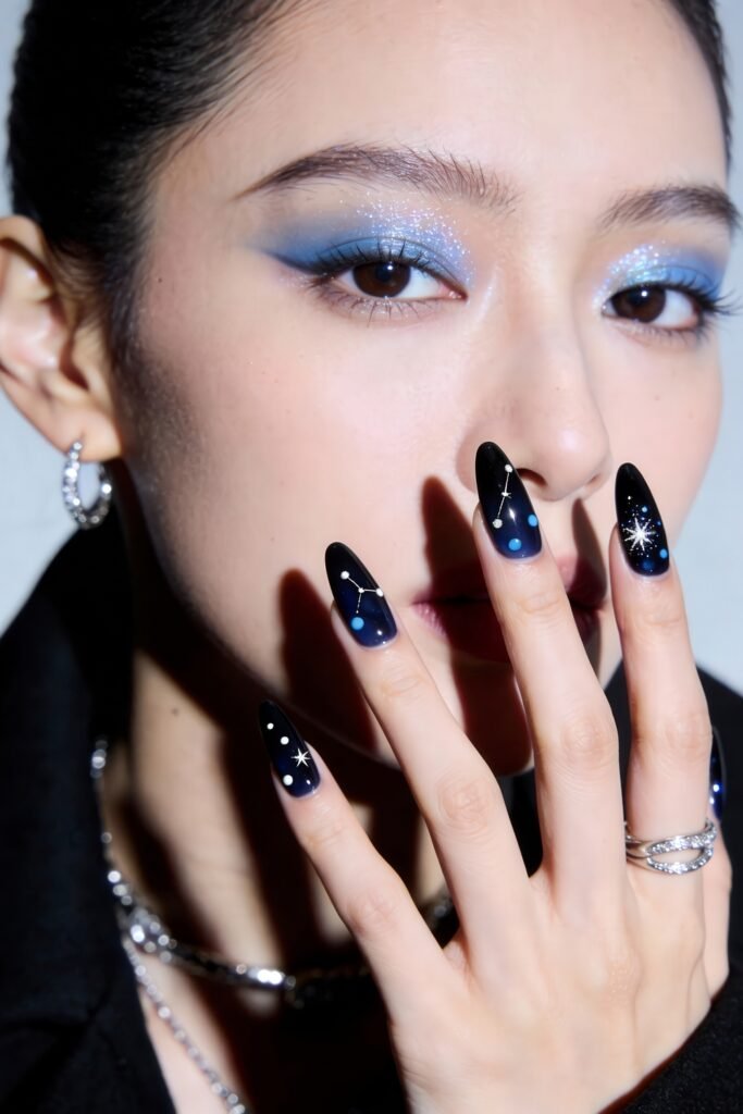 Swaggy Nails That Look Cool and Expensive 18 Almond-shaped black nails with cosmic designs including constellations, stars, and planets—perfect swaggy nails for anyone into galaxy-themed Nail Art Ideas.