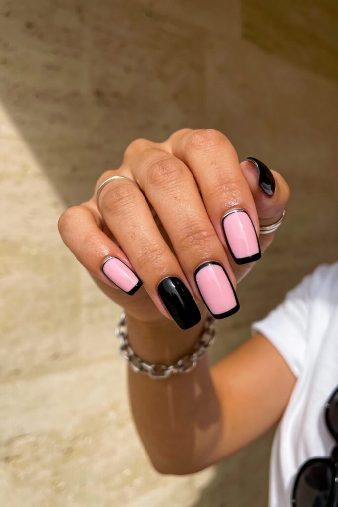 Black And Pink Nails That Look Instantly Chic 20 Square-shaped black and pink nails with a modern twist, featuring glossy pink polish outlined in thin black borders alongside solid black accent nails.