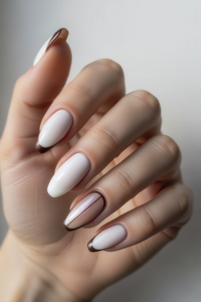 Milky White With Chrome Nails That Look Luxe 23 Almond nails in white with translucent accent nails outlined in deep bronze, including subtle chrome shimmer and fine striping for a warm, stylish twist.
