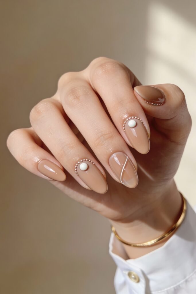 3d Nail Art Ideas That Look Luxe and Wearable 24 Almond-shaped nude nails with soft sheen, decorated with pearl-centered 3d embellishments and fine beaded borders for a classic, feminine style.