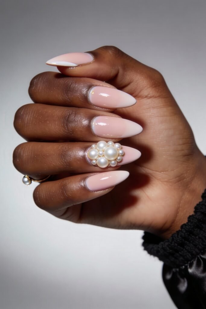 Swaggy Nails That Look Cool and Expensive 23 Glossy almond nails in soft pink ombré with one dramatic accent nail embellished with clustered pearls, blending elegance and charm into a luxe Nail Art Idea.