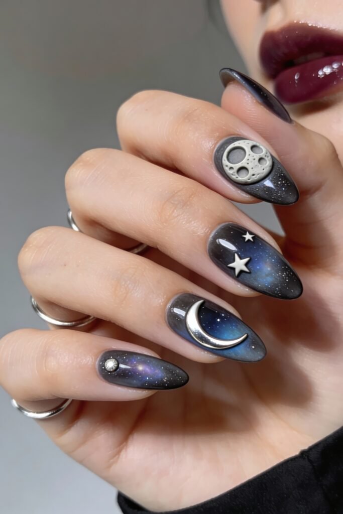 3d Nail Art Ideas That Look Luxe and Wearable 27 Cosmic-themed almond nails with dark galaxy gradients and 3d metallic moon, stars, and planetary details, bringing a striking outer space design to life.