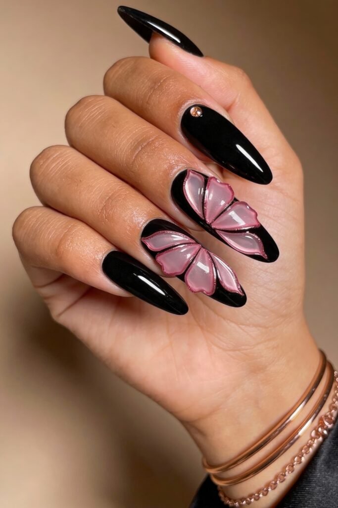 Black And Pink Nails That Look Instantly Chic 24 Glossy black nails with two accent nails forming a large, dimensional butterfly wing design in pink and clear gel, creating a bold black and pink nails look.