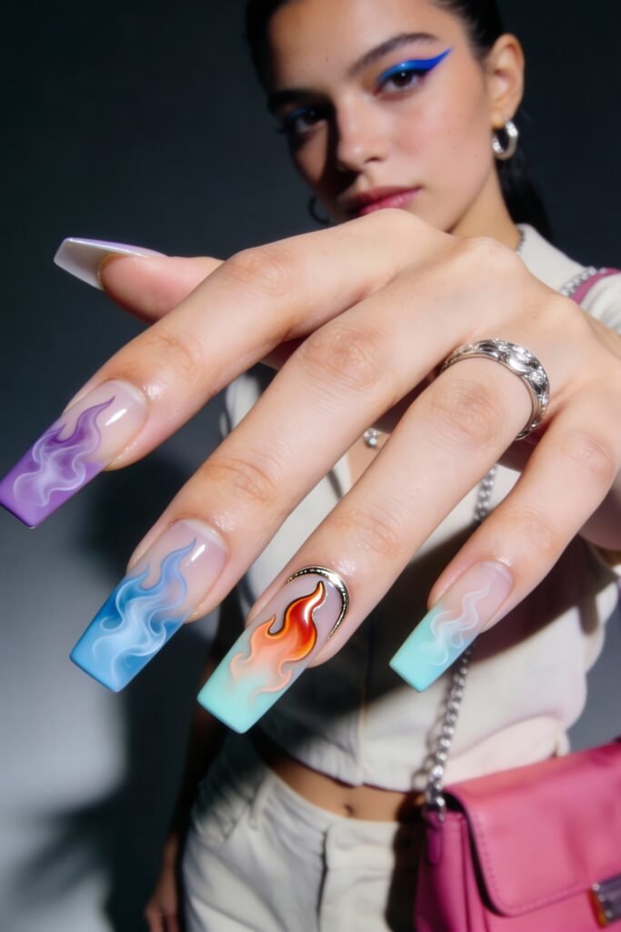 Swaggy Nails That Look Cool and Expensive 28 Long square nails with a translucent base and colorful gradient flames in purple, blue, and orange, with one silver half-moon charm—bold and artistic swaggy nails.