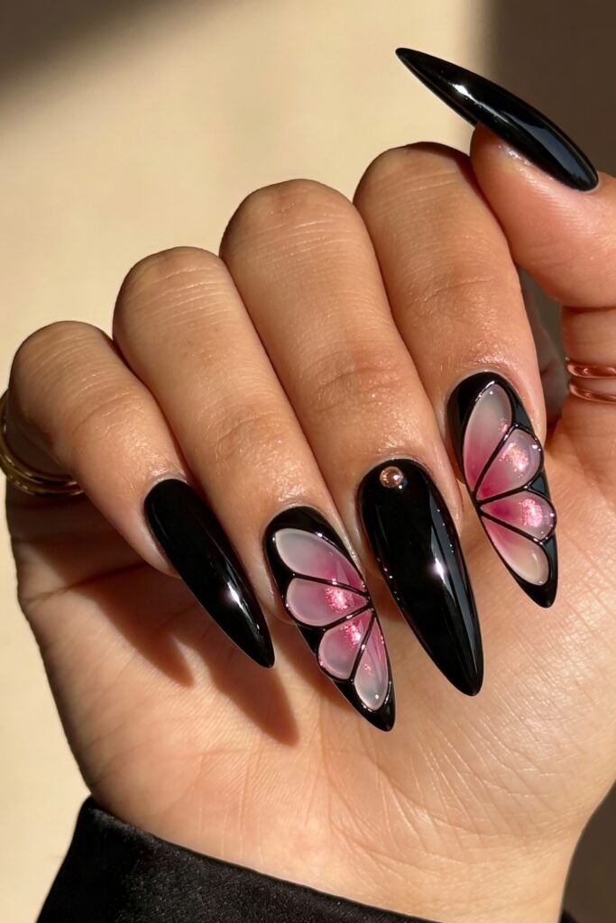 Black And Pink Nails That Look Instantly Chic 25 A dramatic black and pink nails design featuring glossy black polish and two accent nails with shimmering pink butterfly wings outlined in black and set with tiny rhinestones.