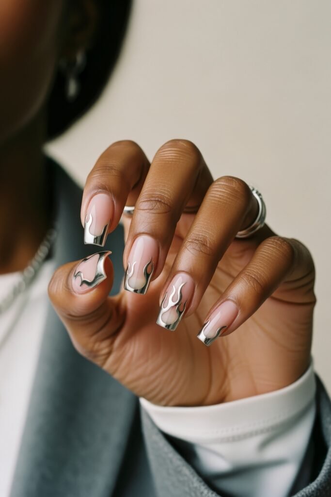 Swaggy Nails That Look Cool and Expensive 4 A bold silver flame design over a natural pink base on squared nails, offering a fiery and metallic twist on Nail Art Ideas.