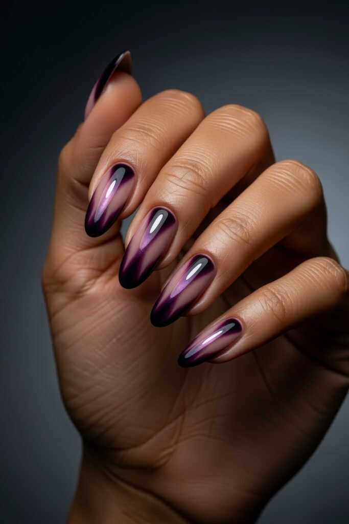 Almond nails with a striking gradient of plum to clear violet, creating a glossy, dimensional look ideal for a dramatic winter manicure.