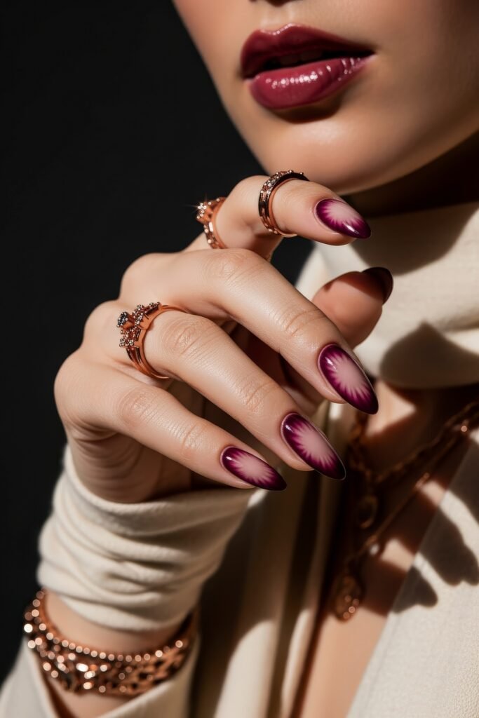 Almond nails in a dramatic deep purple and pale nude radial gradient resembling a frosted flower, ideal for bold winter nails.