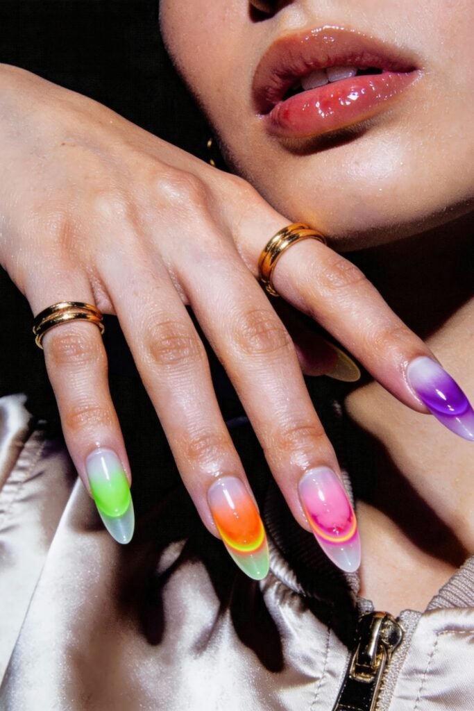Swaggy Nails That Look Cool and Expensive 5 Almond-shaped nails with a smooth ombre in vivid neon shades—green, orange, pink, and purple—finished with glossy jelly-like depth, perfect for standout swaggy nails.