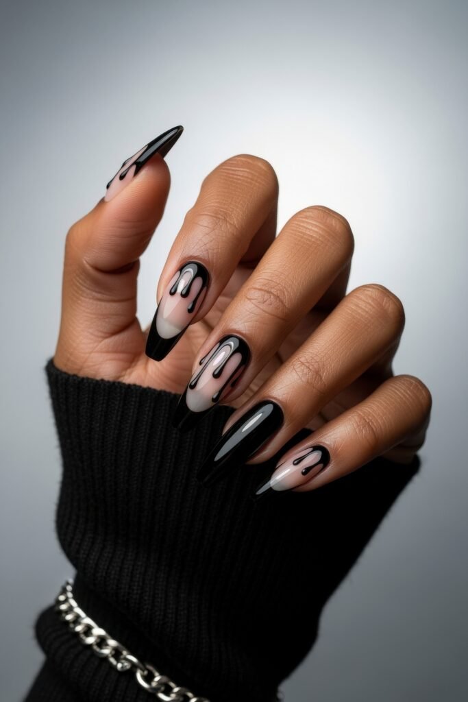 Swaggy Nails That Look Cool and Expensive 8 Sleek black almond nails with glossy black drip designs over a nude base, a dark and dramatic take on trendy Nail Art Ideas.