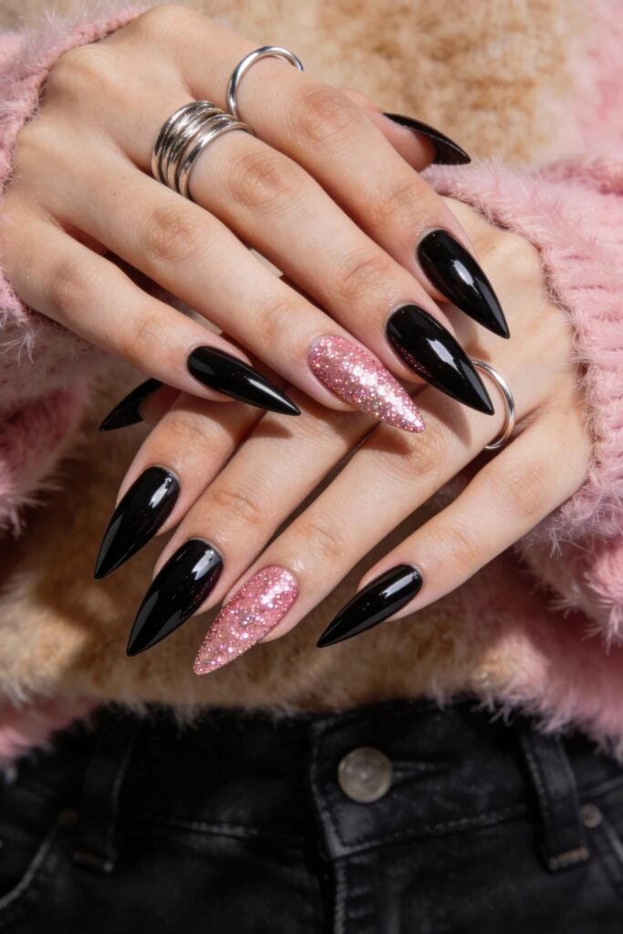 Black And Pink Nails That Look Instantly Chic 7 Glossy black stiletto nails paired with one accent nail on each hand coated in textured pink glitter, adding sparkle and contrast to the black and pink nails combination.