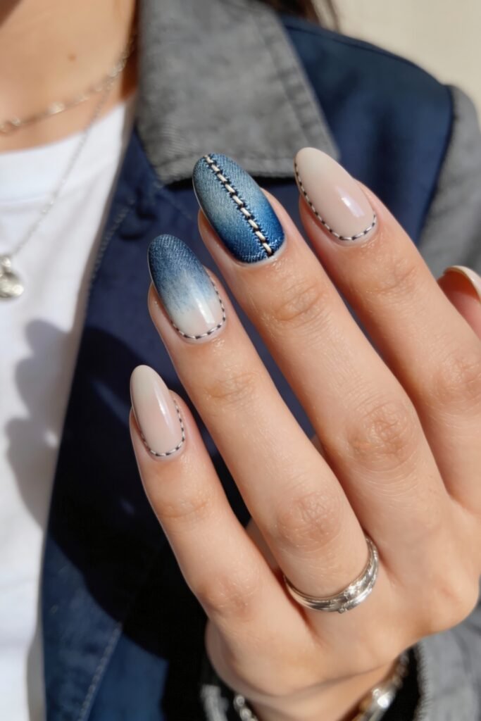 3d Nail Art Ideas That Look Luxe and Wearable 10 Almond-shaped nails with a denim-inspired design, blending blue gradient and nude tones, featuring faux stitching and one nail styled with a realistic 3d seam effect.