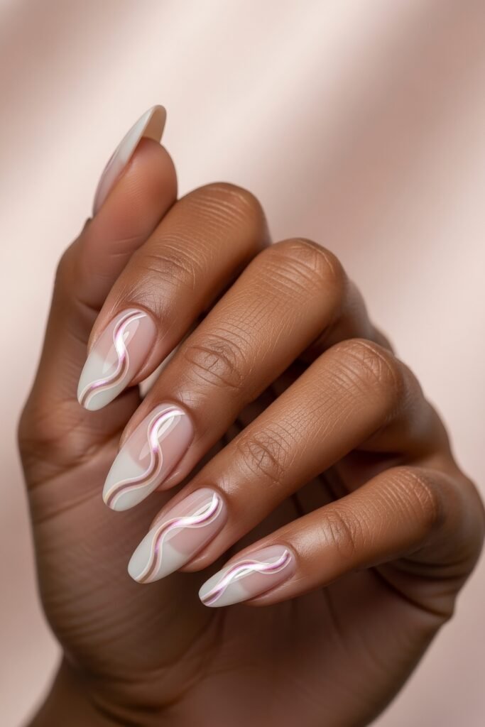 Fresh, Luxe Spring Nail Designs You’ll Want to Save 12 A soft pastel gradient base with pearlescent pink and white wave accents flowing across each nail, perfect for a dreamy spring nails aesthetic.