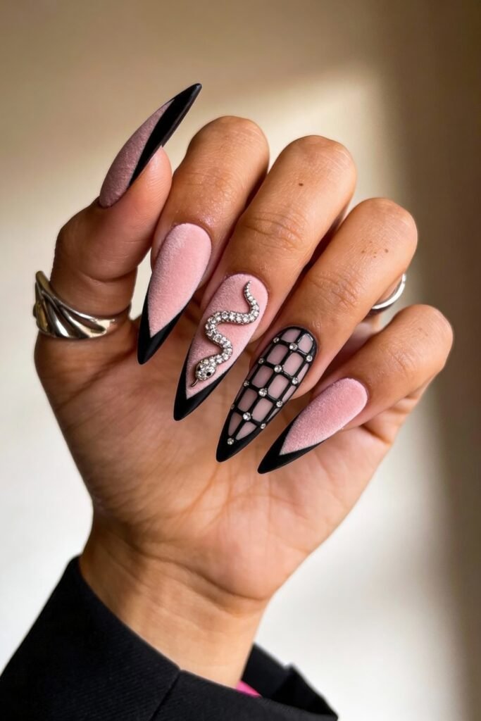 Black And Pink Nails That Look Instantly Chic 10 Long stiletto nails with a soft velvet pink base and sharp black tips, featuring a crystal snake charm and a black mesh design accented with pearls, blending elegance with edgy detail.