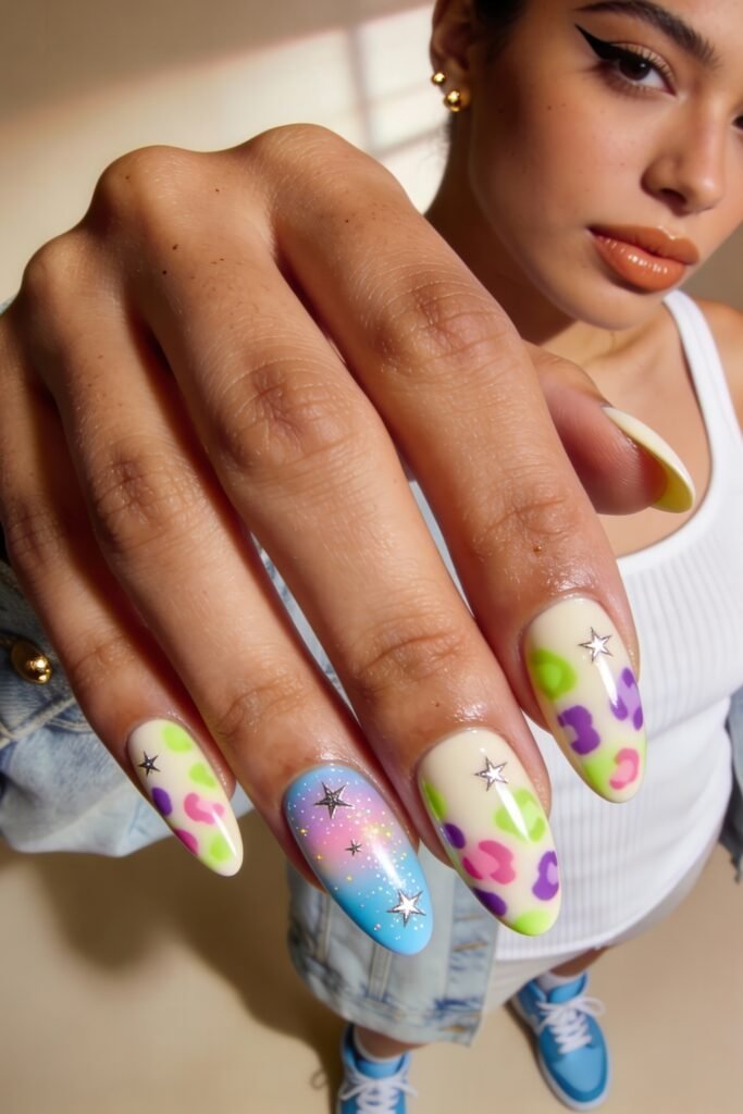 Vibrant and youthful manicure with pastel leopard print, ombré blue glitter, and metallic stars, combining fun Nail Art Ideas with soft street style flair.