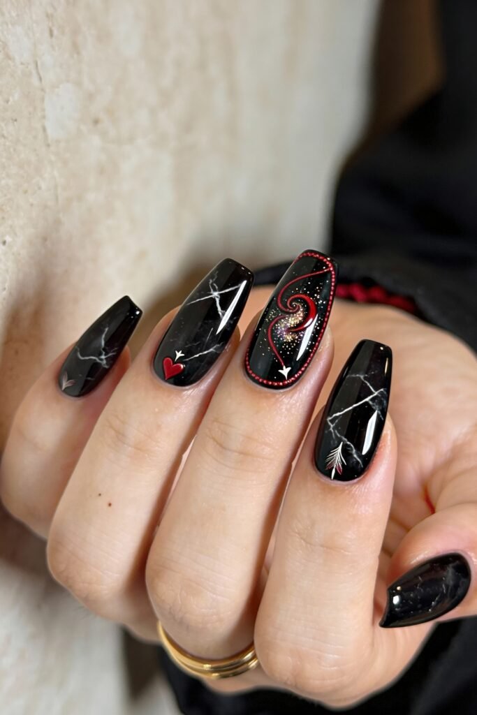 Black Valentines Day Nails That Feel Chic And Romantic 12 Square-shaped black valentines day nails with white marble veining, red heart and arrow details, and a swirling galaxy heart design outlined with red dots for a celestial theme.