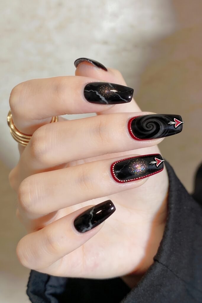 Black Valentines Day Nails That Feel Chic And Romantic 13 Dark marble-inspired black valentines day nails with shimmering swirl accents, arrow graphics, and dotted red outlines adding dimension to the galaxy-themed design.