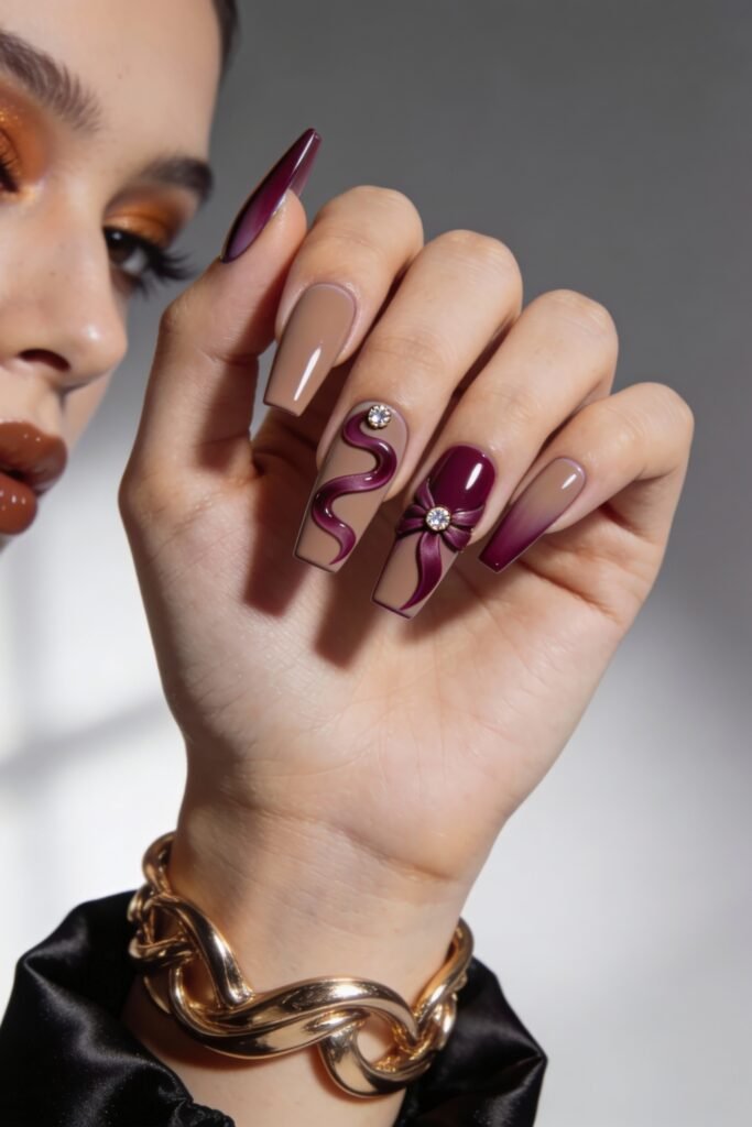 3d Nail Art Ideas That Look Luxe and Wearable 12 Long square nails in matte taupe and burgundy tones, decorated with glossy 3d waves and a raised bow charm centered with rhinestones for a rich, textured finish.
