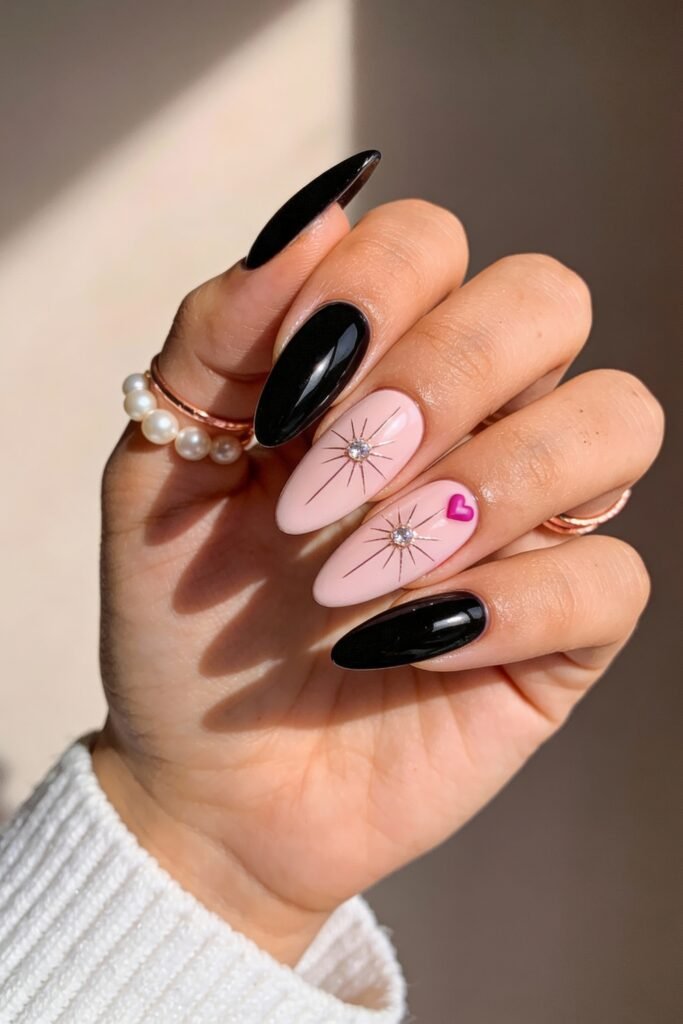 Black And Pink Nails That Look Instantly Chic 11 Almond-shaped nails with alternating glossy black and pale pink bases, the pink nails adorned with silver starburst studs and a tiny hot pink heart for a chic black and pink nails twist.