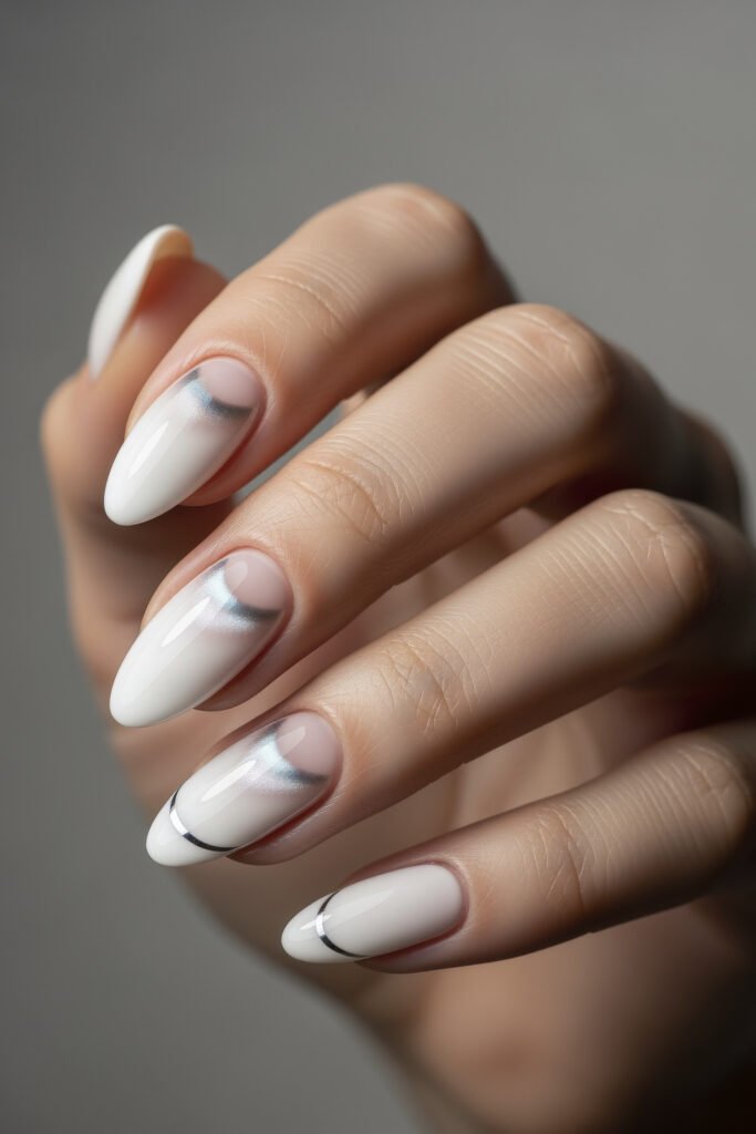 Milky White With Chrome Nails That Look Luxe 13 Almond-shaped nails with a white base, featuring subtle chrome curves and negative space designs for a soft yet modern chrome detail.