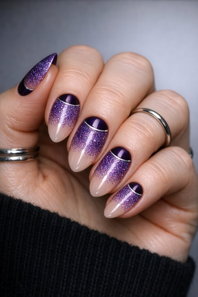Almond-shaped nails with deep purple cuticle crescents blending into glittery lavender tips over a nude base, outlined with silver lines for a festive purple winter nails style.