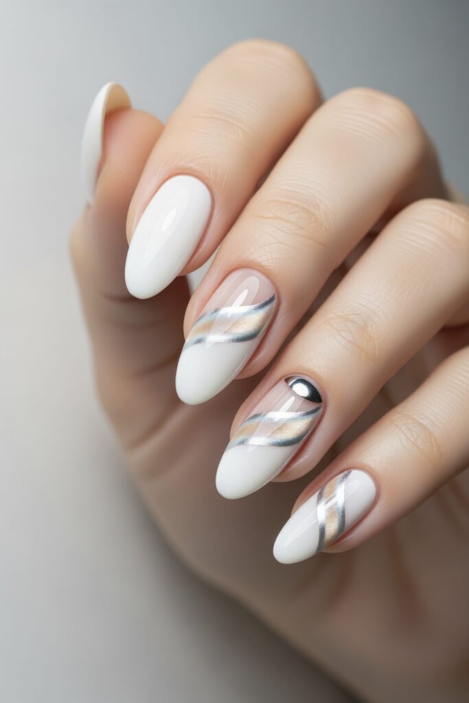 Milky White With Chrome Nails That Look Luxe 14 Almond nails with alternating milky white polish and diagonal metallic swirls, accented by a small chrome half-moon on one finger.