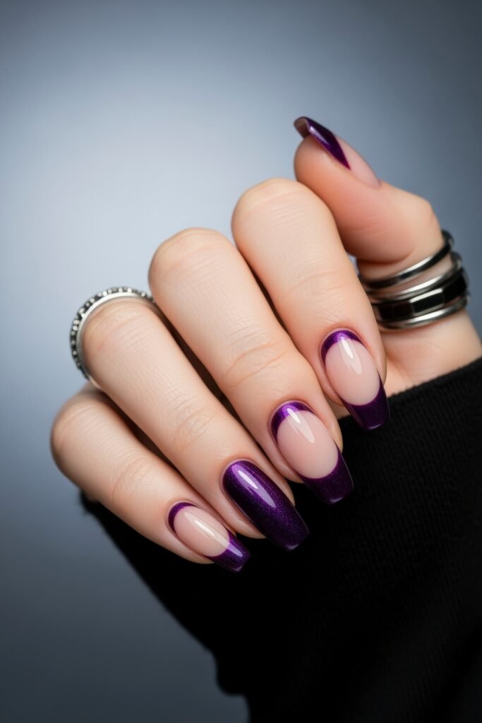 Glossy square nails with a reverse French design in rich purple, paired with a nude base and full-color accents, delivering a bold and chic purple winter nails look.