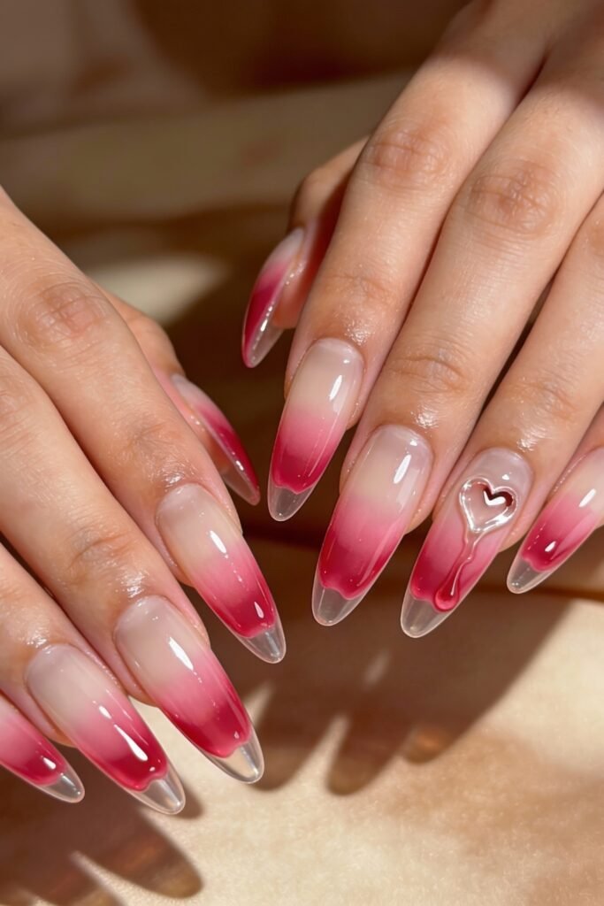 Pink Valentines Nails That Feel Chic, Glossy, and New 15 Long almond pink valentines nails with a deep red ombré tip and a silver heart-shaped key design on the ring finger.