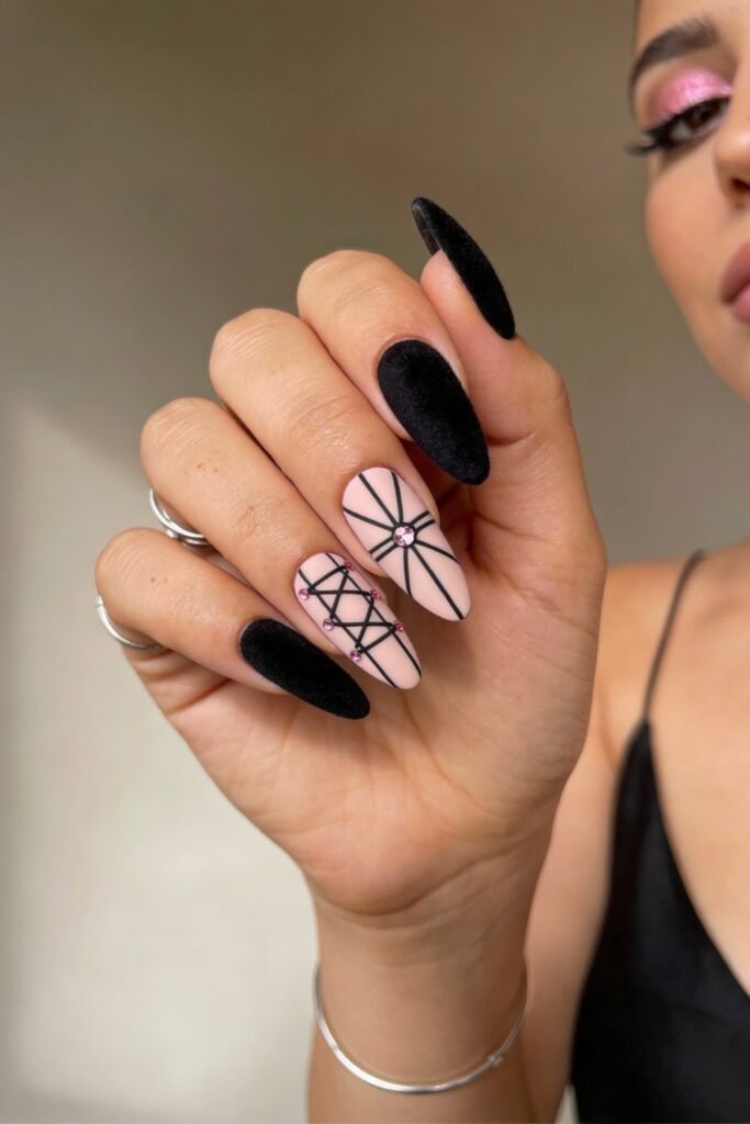 Black And Pink Nails That Look Instantly Chic 14 Textured matte black nails paired with soft pink bases featuring fine black crisscross and starburst designs, detailed with pink and clear rhinestones for a black and pink nails style with contrast.