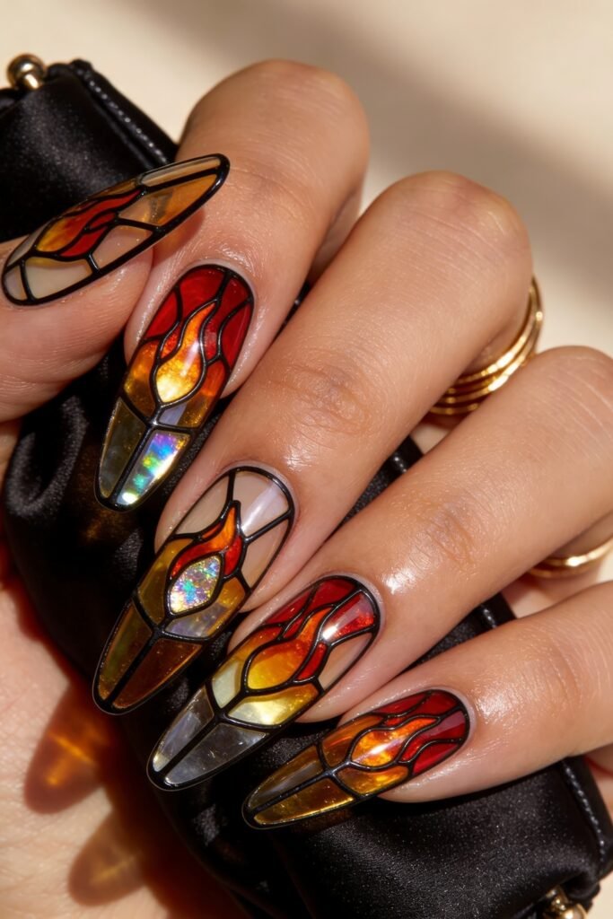 Fire Nails That Look Expensive and Feel Effortless 19 Stained-glass Fire Nails with red and amber flame panels outlined in black and iridescent highlights