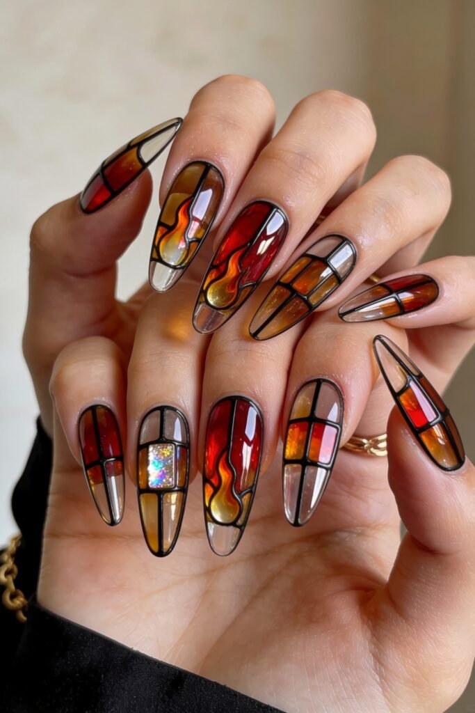 Fire Nails That Look Expensive and Feel Effortless 20 Stained-glass Fire Nails with red, amber, and clear panels outlined in black on long almond nails