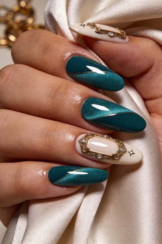 Macro of teal cat-eye almond nails and a cream accent nail with an antique gold frame and rhinestones on satin fabric