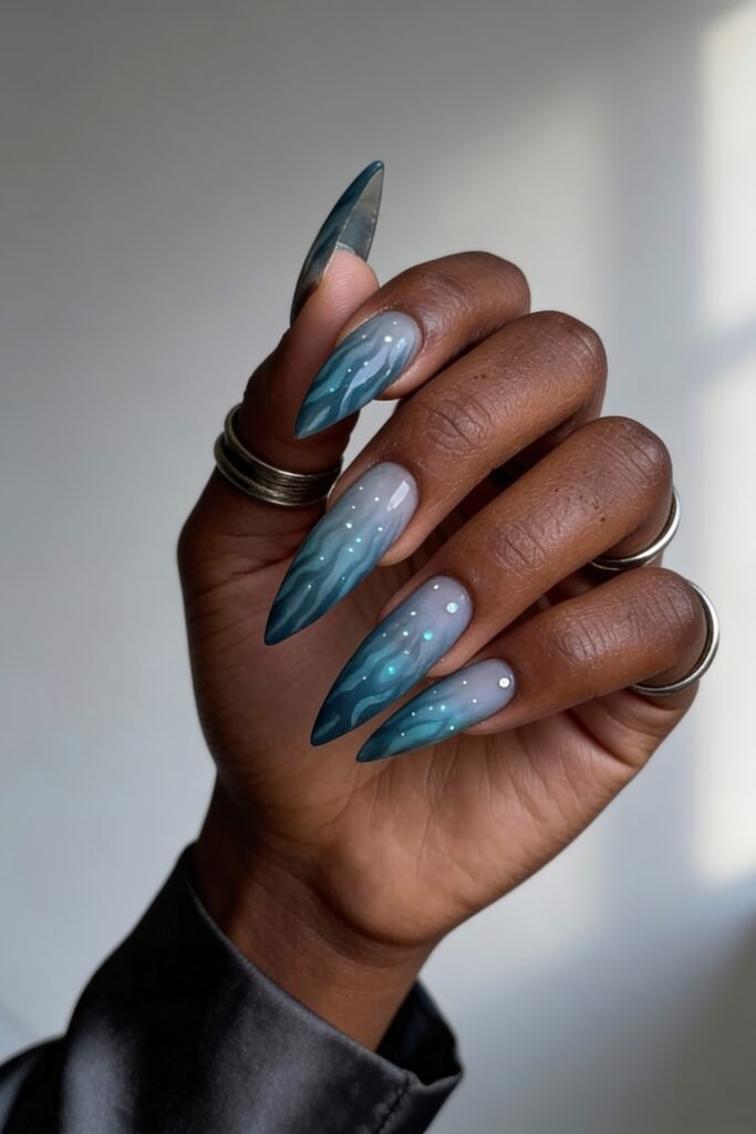 Ocean-inspired avatar nails in teal and smoky gray gradient with gentle ripple effects and scattered iridescent dots, resembling glowing bubbles or underwater light reflections.
