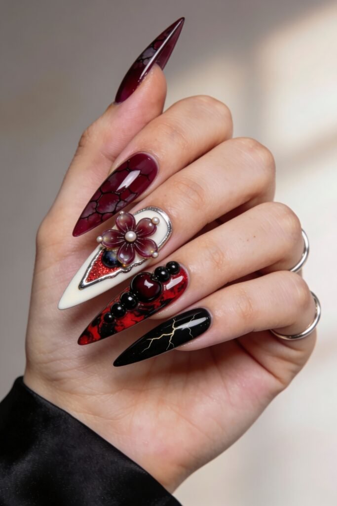 Intricate Stranger Things-inspired nails with cracked burgundy polish, pearl-studded Demogorgon flower, raised black beads over red swirls, and a gold lightning bolt on black.