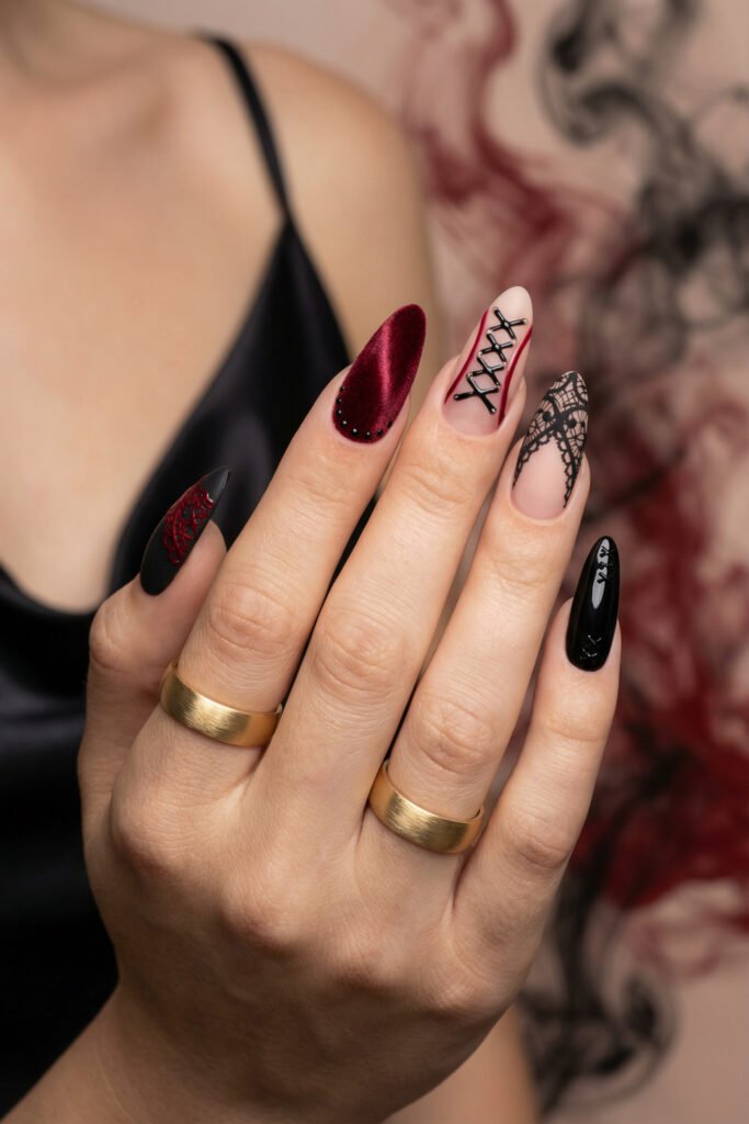 Black and Red Nails for a Bold, Polished Look 9 Hand with gold rings displaying black and burgundy almond nails with corset lace patterns a velvet red accent and glossy black details