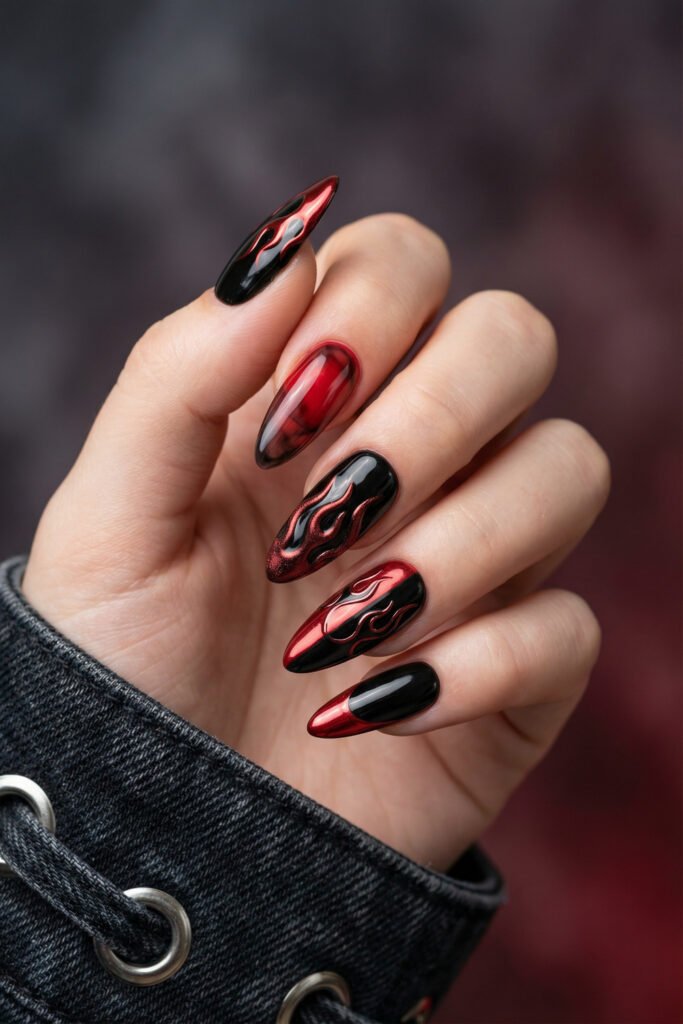 Black and Red Nails for a Bold, Polished Look 10 Hand with silver rings and glossy almond nails in black and metallic red featuring flame art and smoky red ombre