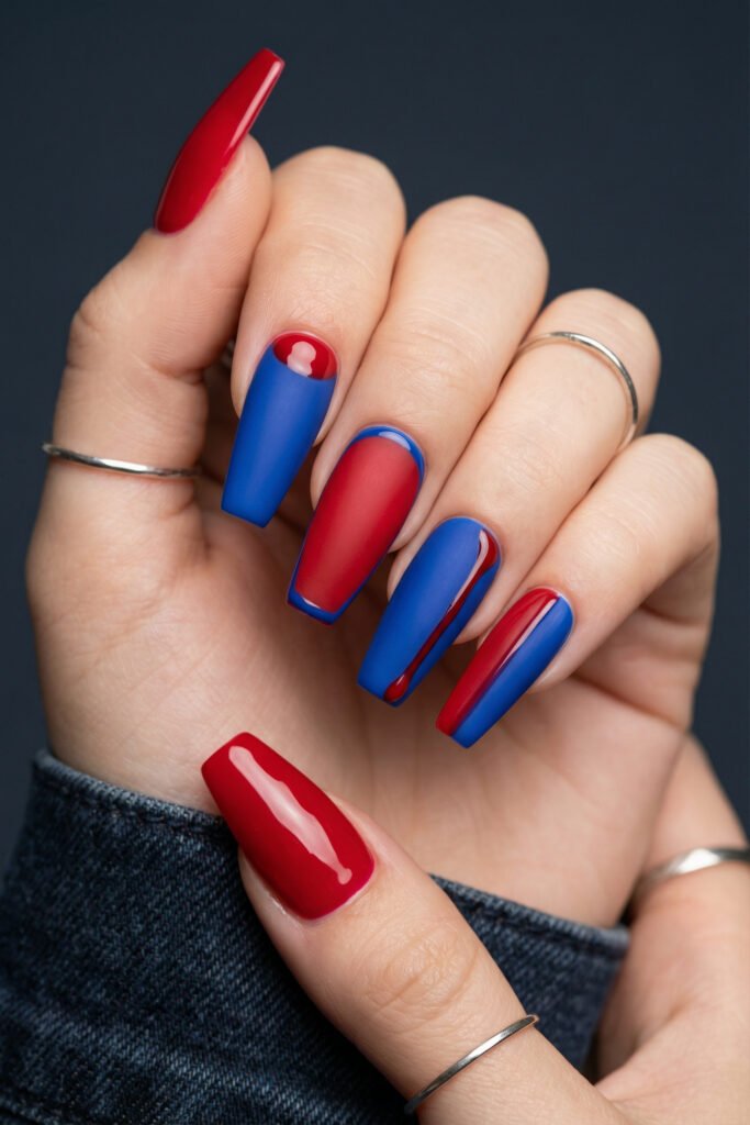 Long coffin blue and red nails with matte cobalt and crimson polish, glossy curved details, and bold modern contrast on statement-length nails
